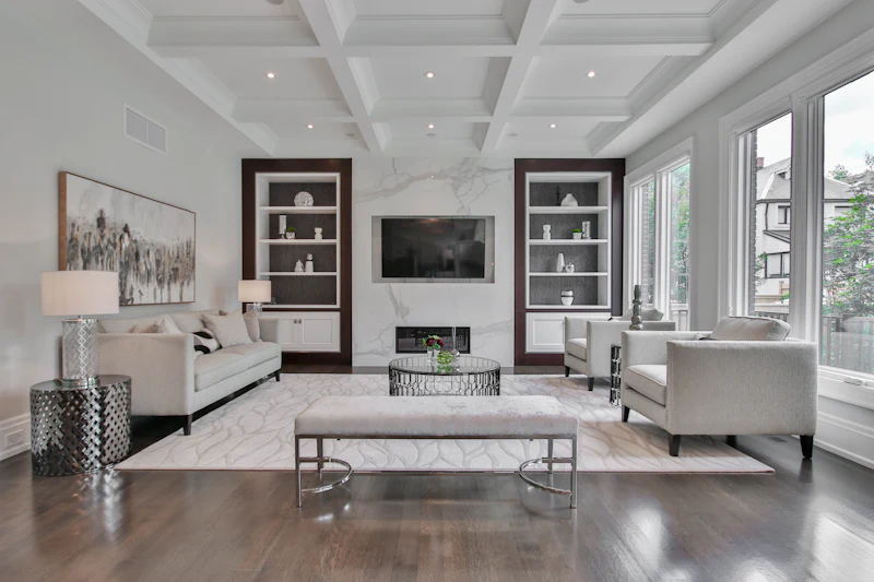 Living room with white built-in bookshelves flanking a fireplace