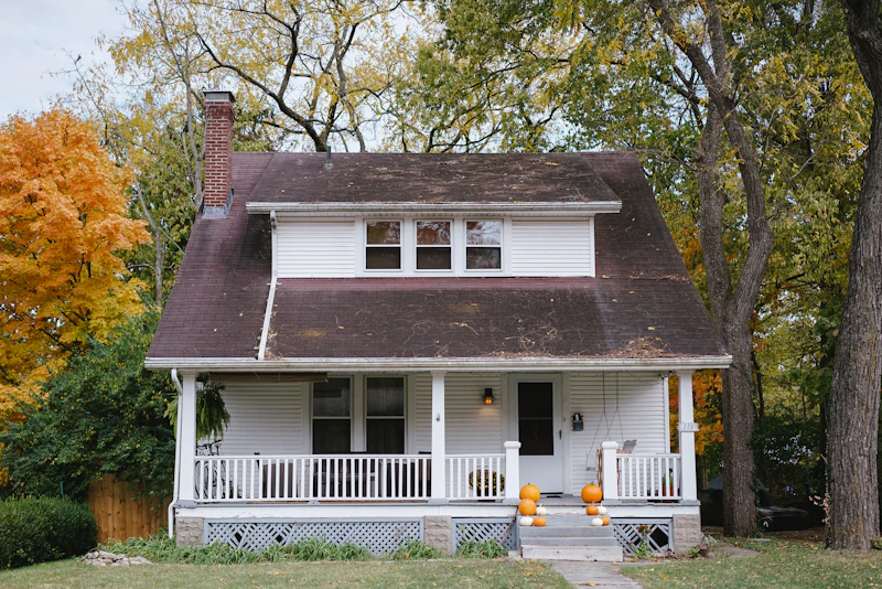 Bungalow-style home with a covered front porch and white railings