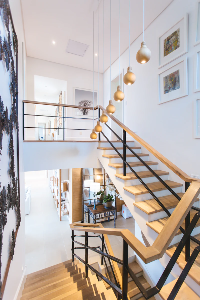 Staircase with wood treads and a black metal railing